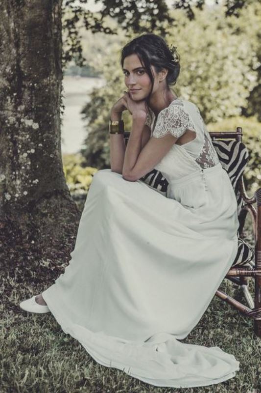 A romantic yet casual wedding dress with a lace back, cap sleeves and a plain skirt