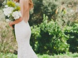 a sexy lace mermaid wedding dress with an open back and train is a beautiful idea for a backyard bride
