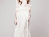 a baggy lace wedding dress with short sleeves, a draped waistline and a tiered skirt