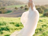a romantic wedding dress with a lace bodice on spaghetti straps and an open back and a flowy skirt