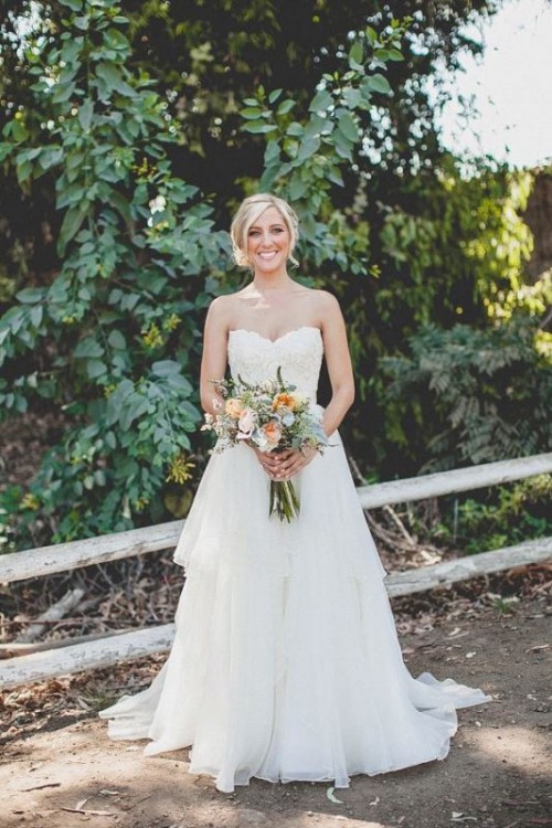 a strapless mermaid wedding dress with a lace bodice and a layered skirt with a train is classics