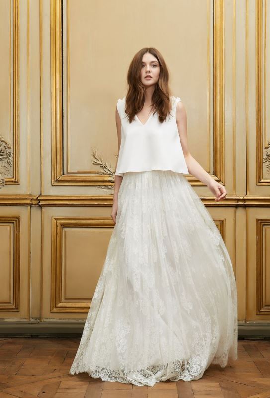 A non typical wedding separate with a plain top with floral shoulders and an airy lace A line skirt