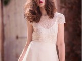 a chic modern bridal combo of a white plain wedding dress on straps and a sheer embellished cropped top