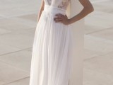 a Grecian-inspired wedding dress with a lace bodice and a draped detail and pleated skirt