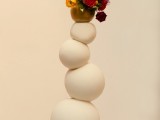 a weird stacked ball wedding cake with a bit of bold fresh blooms on top is a lovely idea for a whimsical wedding