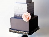 an elegant and sleek square wedding cake with a white, ombre and black tier, with a bit of fringe and a fresh blush bloom is a stylish idea