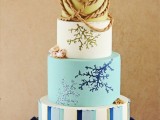 a coastal wedding cake with a striped tier, with corals painted on the tiers and some rope and seashells of sugar is a spectacular solution for a seaside wedding