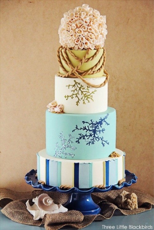 a coastal wedding cake with a striped tier, with corals painted on the tiers and some rope and seashells of sugar is a spectacular solution for a seaside wedding