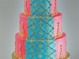 a colorful pink and blue wedding cake with yelow patterns and pearls is a lovely idea for a colorful and bold wedding