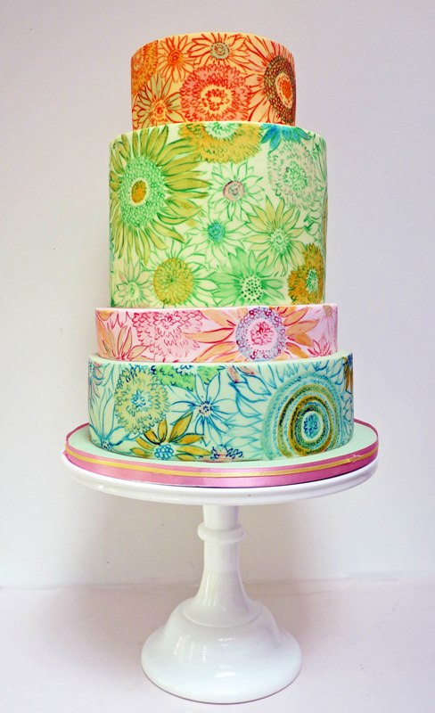 a super colorful wedding cake with mismatching floral pattern tiers is an amazing idea for a bold wedding