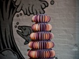 a purple wedding cake decorated with colorful semi circle sugar pieces is an eye-catchy and bright idea for a wedding