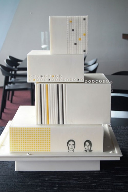a quirky modern square wedding cake in white, with colorful prints and bold geo patterns plus photos of the couple on the bottom tier is a lovely idea