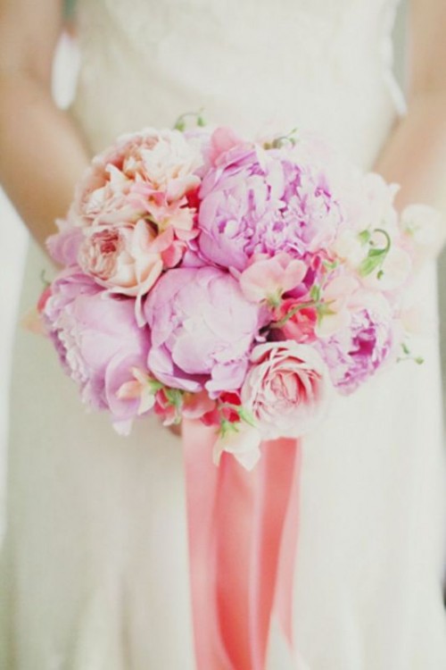 hot pink and peachy peony wedding bouquet with long ribbons is a bold idea for a spring or summer bride