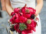 a bold coral peony wedding bouquet with artichokes, succulents and seed pods is a bold idea for a summer or fall wedding