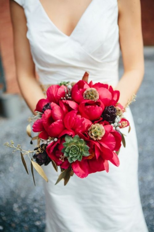 a bold coral peony wedding bouquet with artichokes, succulents and seed pods is a bold idea for a summer or fall wedding