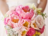 a colorful wedding bouquet with blush and pink peonies, succulents, billy balls and greeery is amazing for spring or summer
