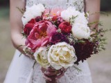a bold and cool wedding bouquet with white, coral and deep purple peonies, greenery is ideal for a summer or fall wedding