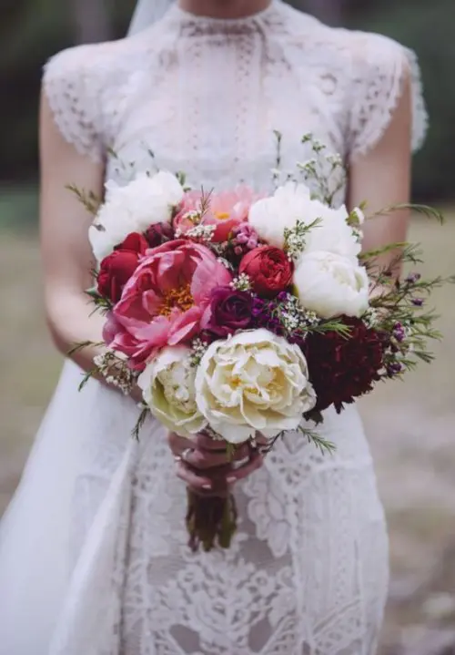 a bold and cool wedding bouquet with white, coral and deep purple peonies, greenery is ideal for a summer or fall wedding