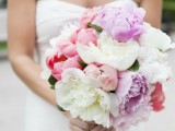 a lush coral, lilac and white peony wedding bouquet for a spring or summer wedding