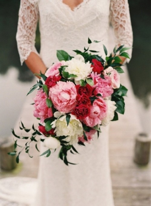 a bold pink, red and white peony wedding bouquet with greenery for a bright spring or summer wedding
