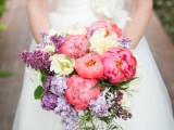 a bold wedding bouquet with coral and white peonies and lilac is a beautiful solution for a bright spring wedding