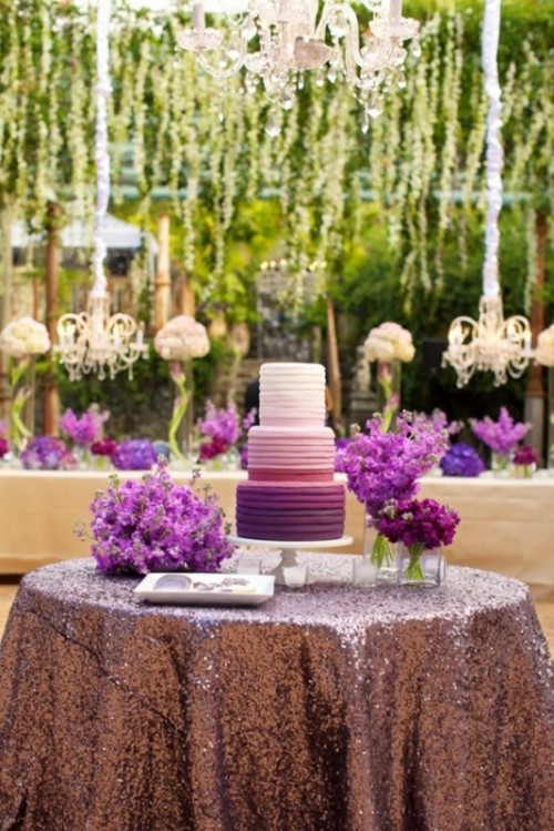 an ombre white to blush and radiant orchid wedding cake surrounded by radiant orchid florals for a bold wedding