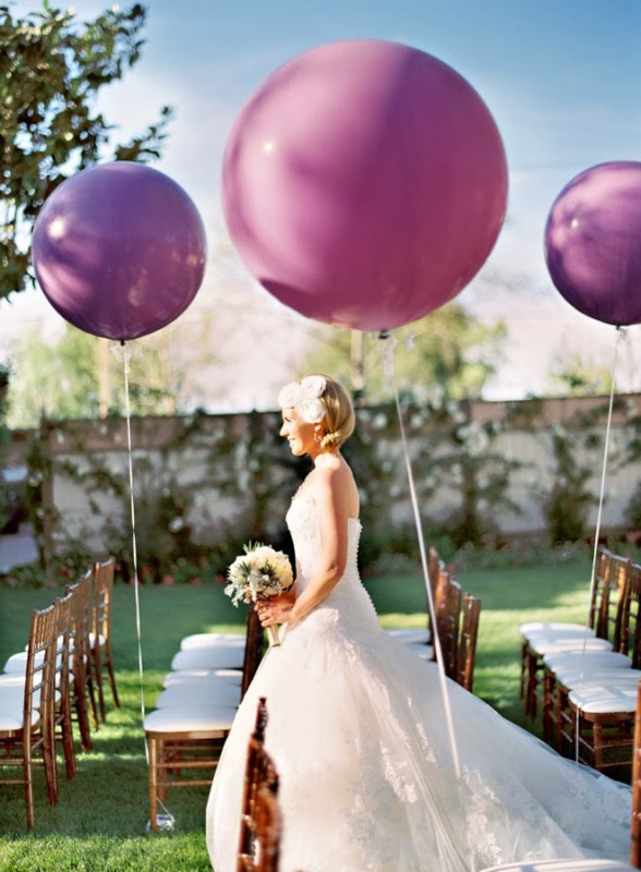 Radiant orchid balloons decorating the aisle chairs are amazing to make the space look modern and fun