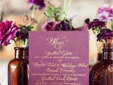 a radiant orchid wedding menu with gold lettering, radiant orchid blooms in apothecary bottles for a refined wedding centerpiece