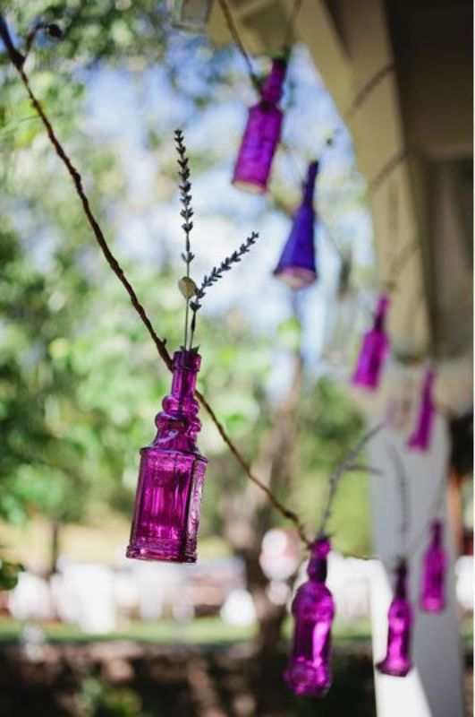 a gorgeous garland of radiant orchid bottles with lavender will be a fun and whimsical decor idea for a bright wedding
