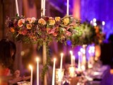 colorful blooms, tall and thin candles and mercury glass candle holders to illuminate long tables