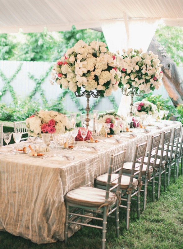 Oversized floral topiaries and centerpieces make the tables very chic