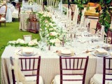 neutral tablescapes with greenery and blush blooms plus candles