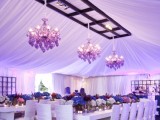 wedding tablescapes with lush purple, burgundy and pink blooms and pink chandeliers