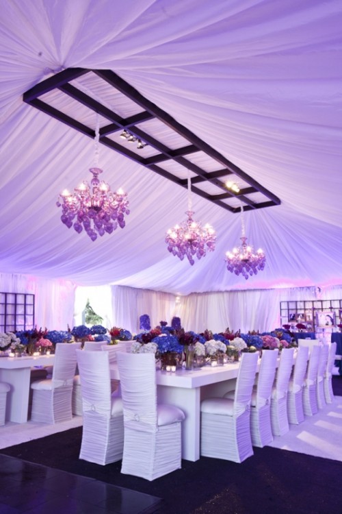 wedding tablescapes with lush purple, burgundy and pink blooms and pink chandeliers