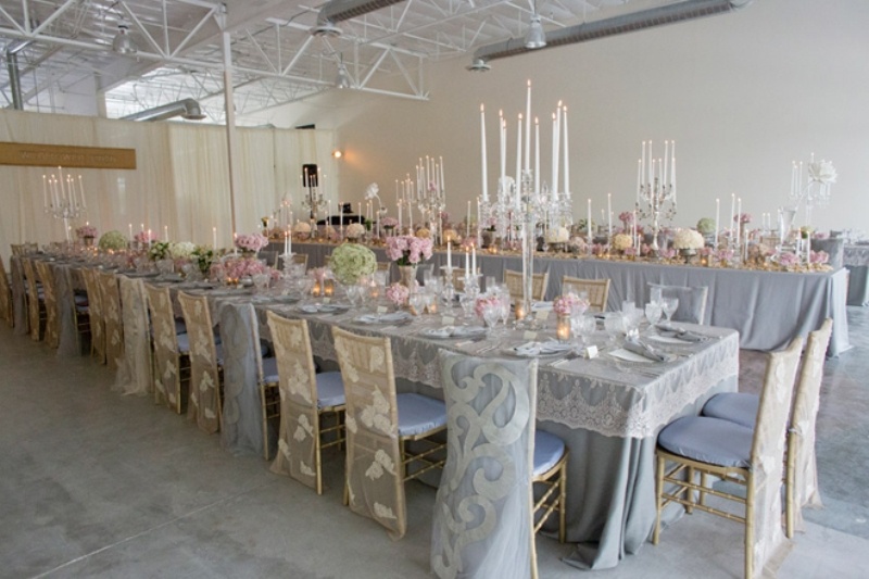 Grey tables, pink and green blooms, candles and matching lace chair covers