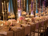 formal wedding tables with white tablecloths, long thin candles, pink and white blooms in centerpieces