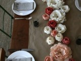 a colorful paper flower wedding table runner is a budget-friendly substitution for a usual wedding table runner and centerpieces