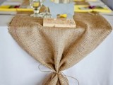 a burlap wedding table runner with twine will give a cool rustic feel to the tablescape and it’s very budget-friendly