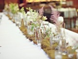 a moss wedding table runner with herbs, wildflowers and foliage is a very cool idea for a woodland wedding