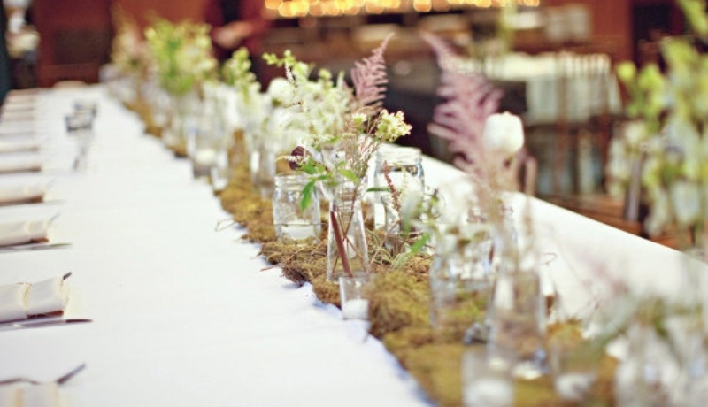A moss wedding table runner with herbs, wildflowers and foliage is a very cool idea for a woodland wedding