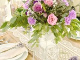 an elegant white lace wedding table runner and bright contrasting flowers for a vintage wedding