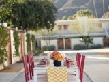 a yellow and white chevron wedding table runner will bring color and pattern to the tablescape