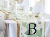a fabric table runner with a wood print table runner and a botanical one with a monogram looks cool and chic