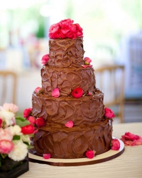 a textural chocolate buttercream wedding cake with bright pink roses and petals is a fantastic idea for a modern wedding