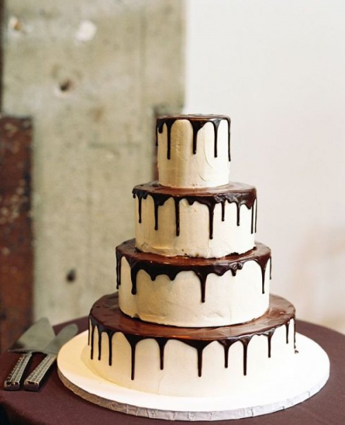 a round white buttercream wedding cake with chocolate drip is a chic and bold idea for a wedding, it's a very contrasting and bright idea