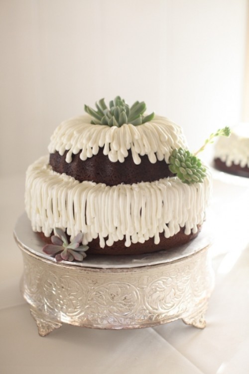a two-tier chocolate bundt wedding cake with glazing and succulents is a pretty and cool alternative to a usual wedding cake, great for a more relaxed wedding