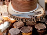 a chocolate wedding cake with a raw edge and a swirl on top that imitates wood slices is a great idea for a woodland wedding