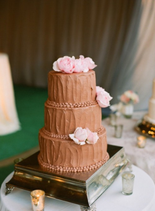 a textural chocolate buttercream wedding cake with pink blooms is a stylish and cool idea for a spring or summer wedding