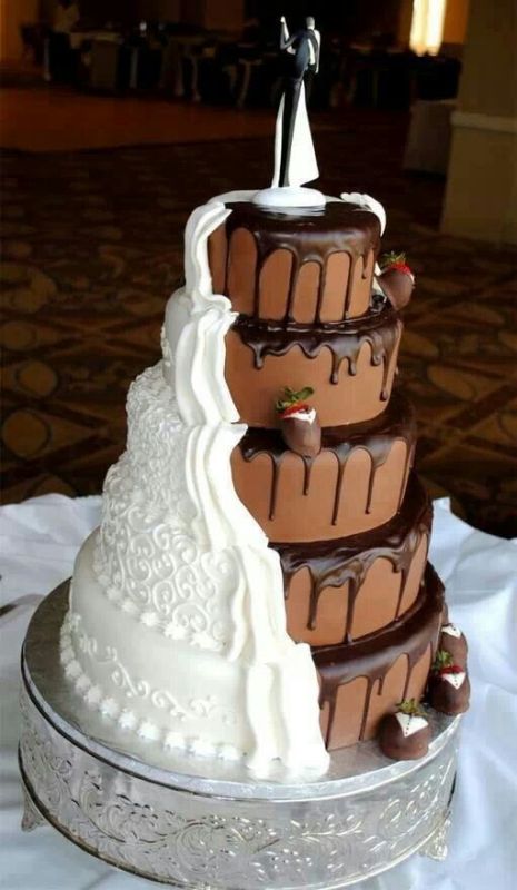 a chocolate wedding cake with chocolate drip, beautiful white buttercream for decor, chocolate dipped strawberries, chic couple cake toppers is refined and chic
