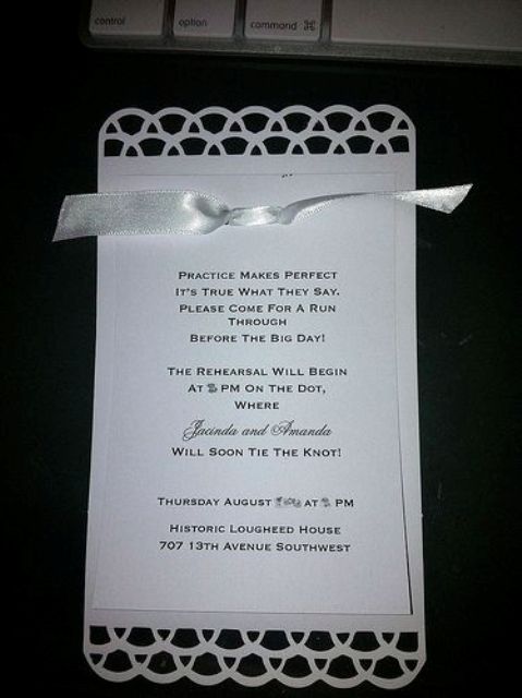 an elegant white rehearsal dinner invitation with cutouts and a white silk ribbon is super chic and timeless